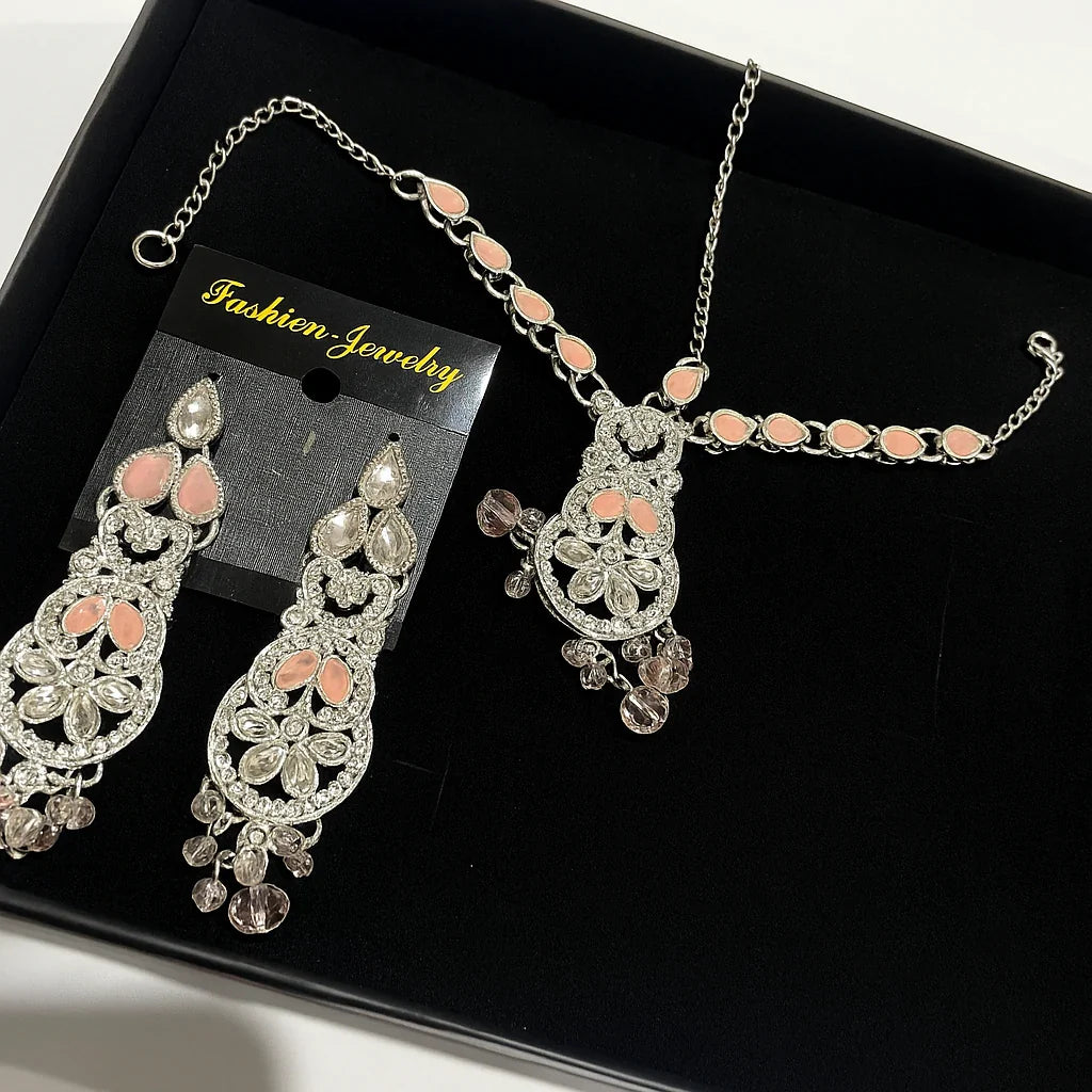 Jewelry set with necklace and earrings on a black tray, labeled 'Fashion Jewelry'.