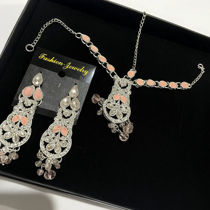Jewelry set with necklace and earrings on a black tray, labeled 'Fashion Jewelry'.