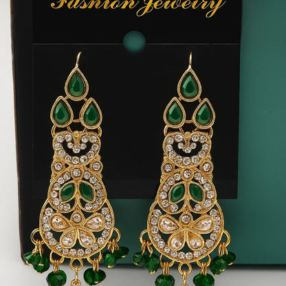 Ornate gold and green earrings on a black card with 'Fashion Jewelry' text.