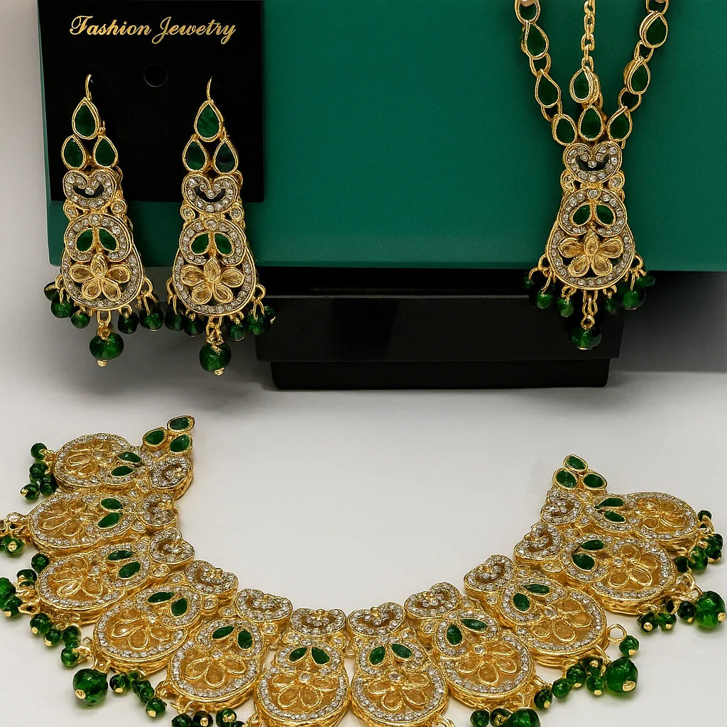 Gold and green jewelry set including necklace, earrings, and bracelet on a white background.