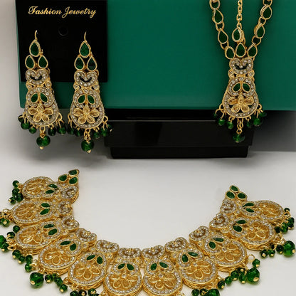 Gold and green jewelry set including necklace, earrings, and bracelet on a white background.